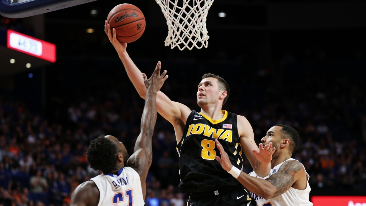 Iowa guard Alvaro Folgueiras releasing a corner three-pointer with Florida defenders lunging too late and the shot clock showing 4.5 seconds