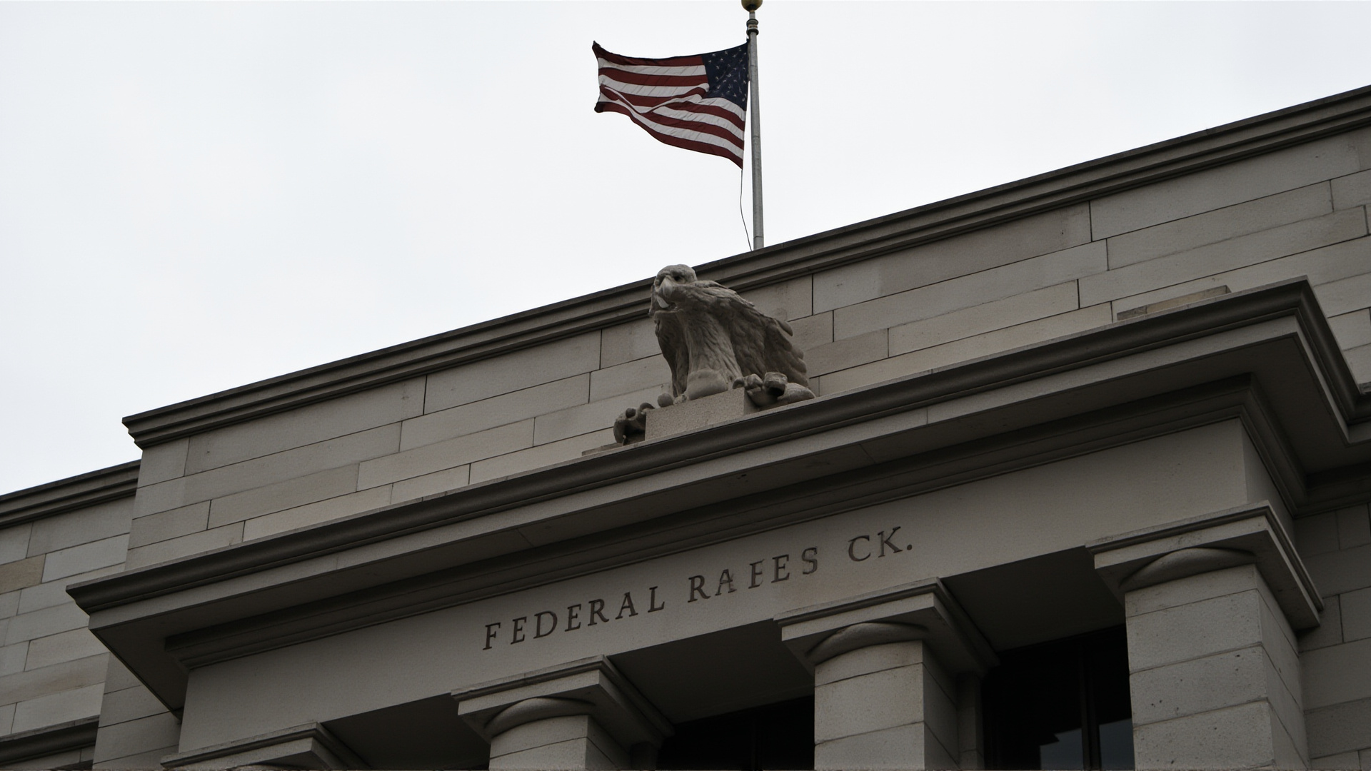 The Federal Reserve building facade with its eagle emblem, shot from below, overcast sky, institutional weight
