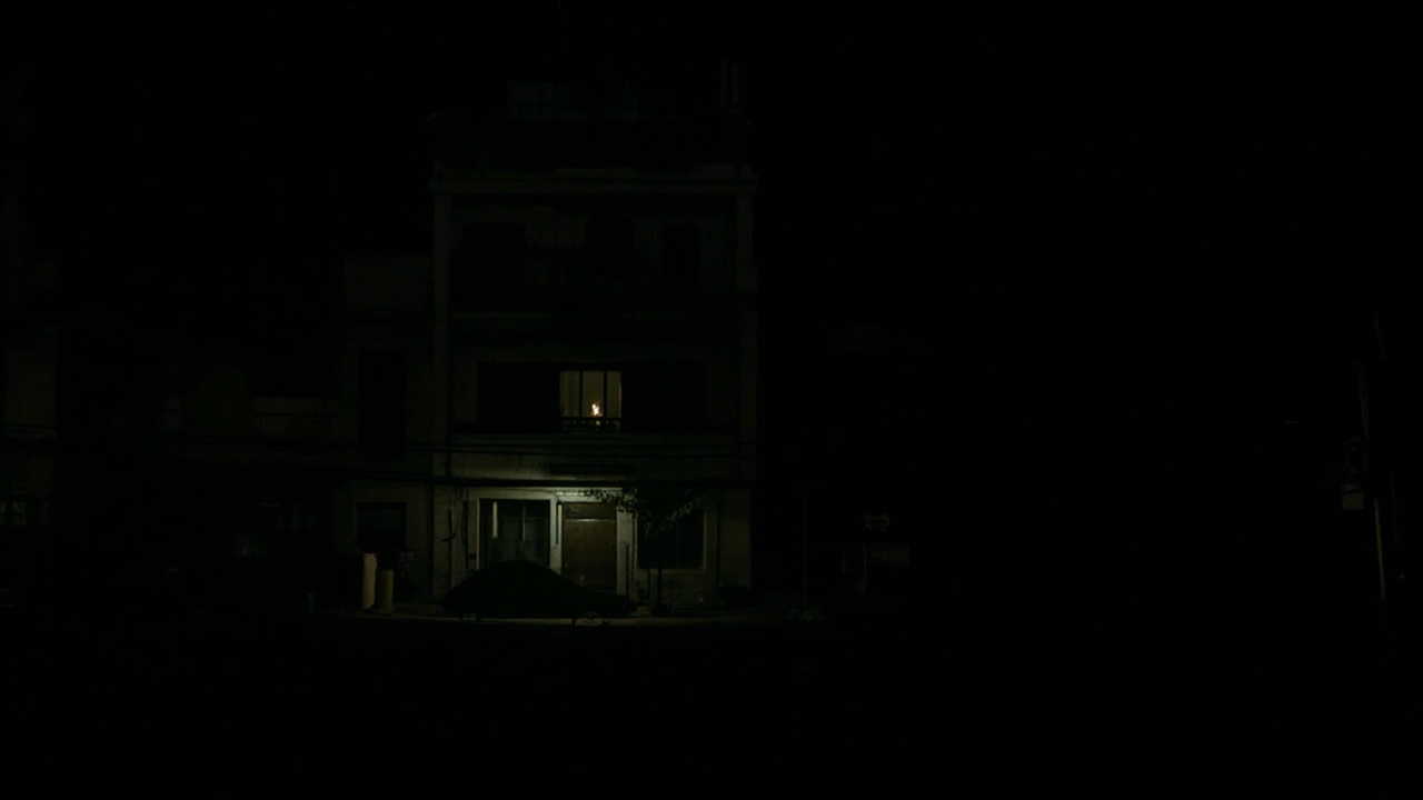 Havana neighborhood in darkness, single candle visible in window
