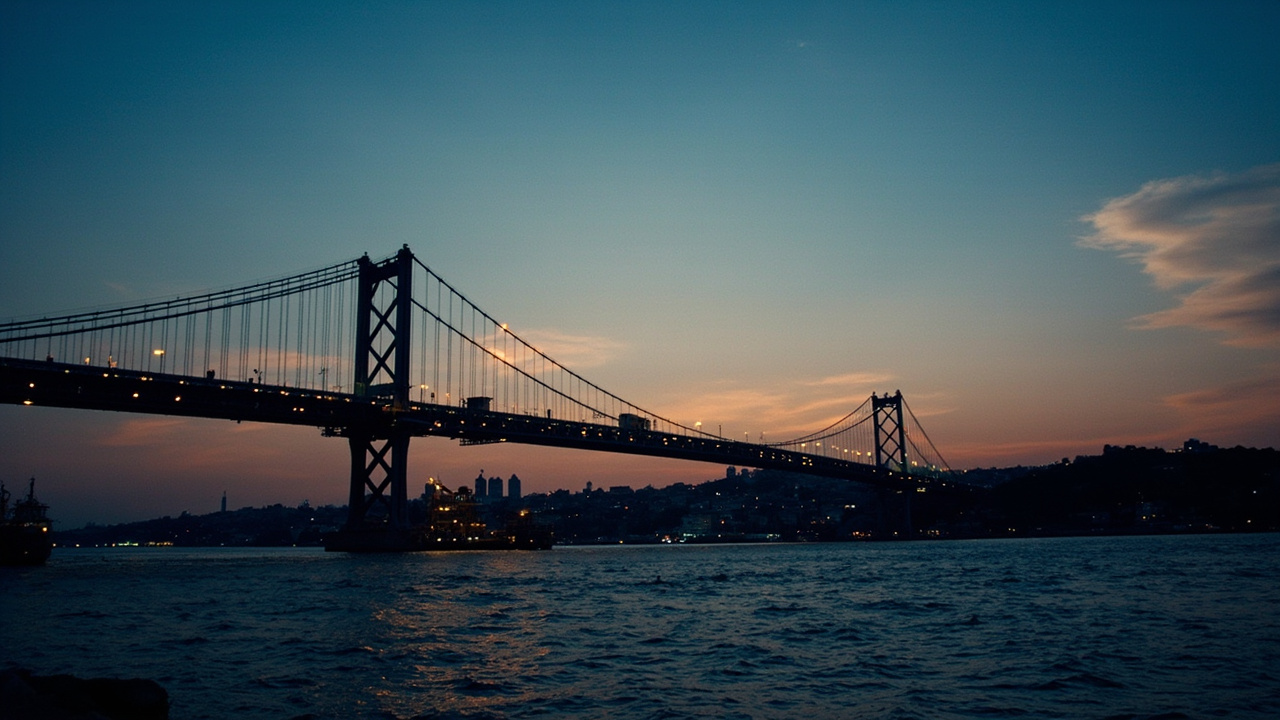 Bosphorus Bridge at dusk, cargo ships beneath, Istanbul skyline