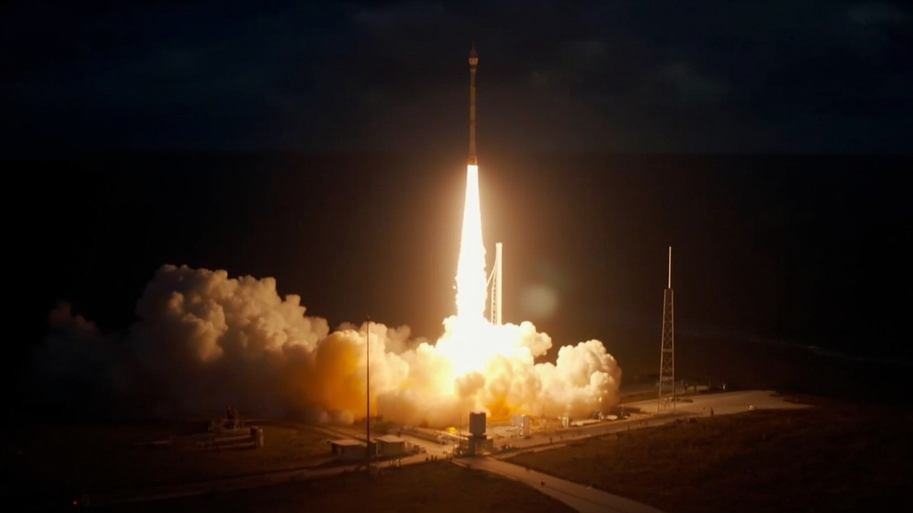A Falcon 9 rocket launching at night from Cape Canaveral, fire and steam visible below