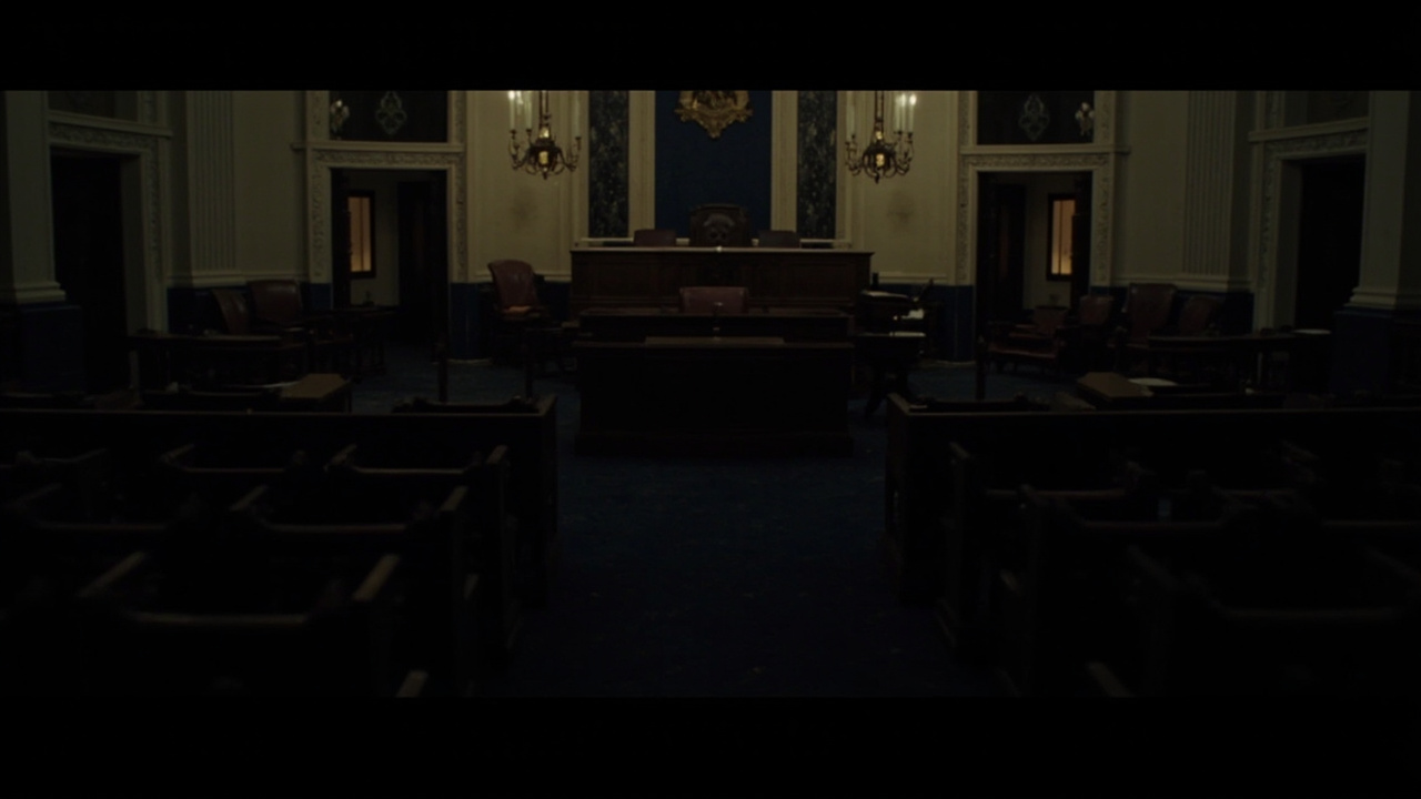 The empty House chamber floor with the session clock visible above the Speaker's chair