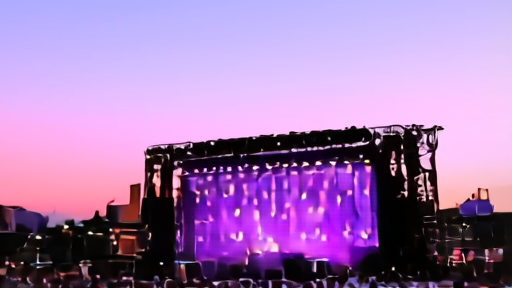 Empty Coachella main stage from the field after a headliner set, rigging cooling under pink lights.