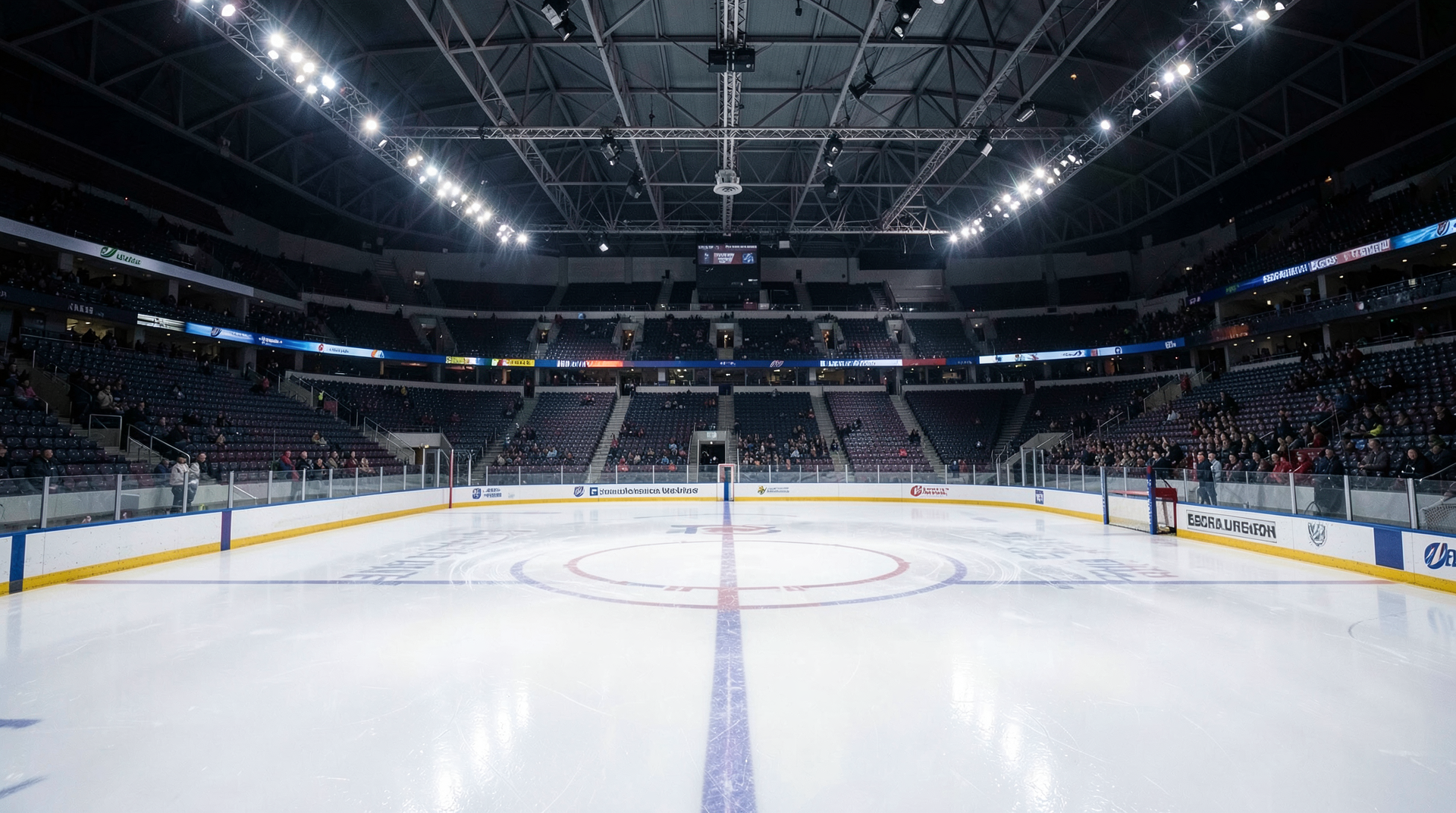Empty hockey rink with goal crease visible and Zamboni finishing ice resurfacing under arena lights