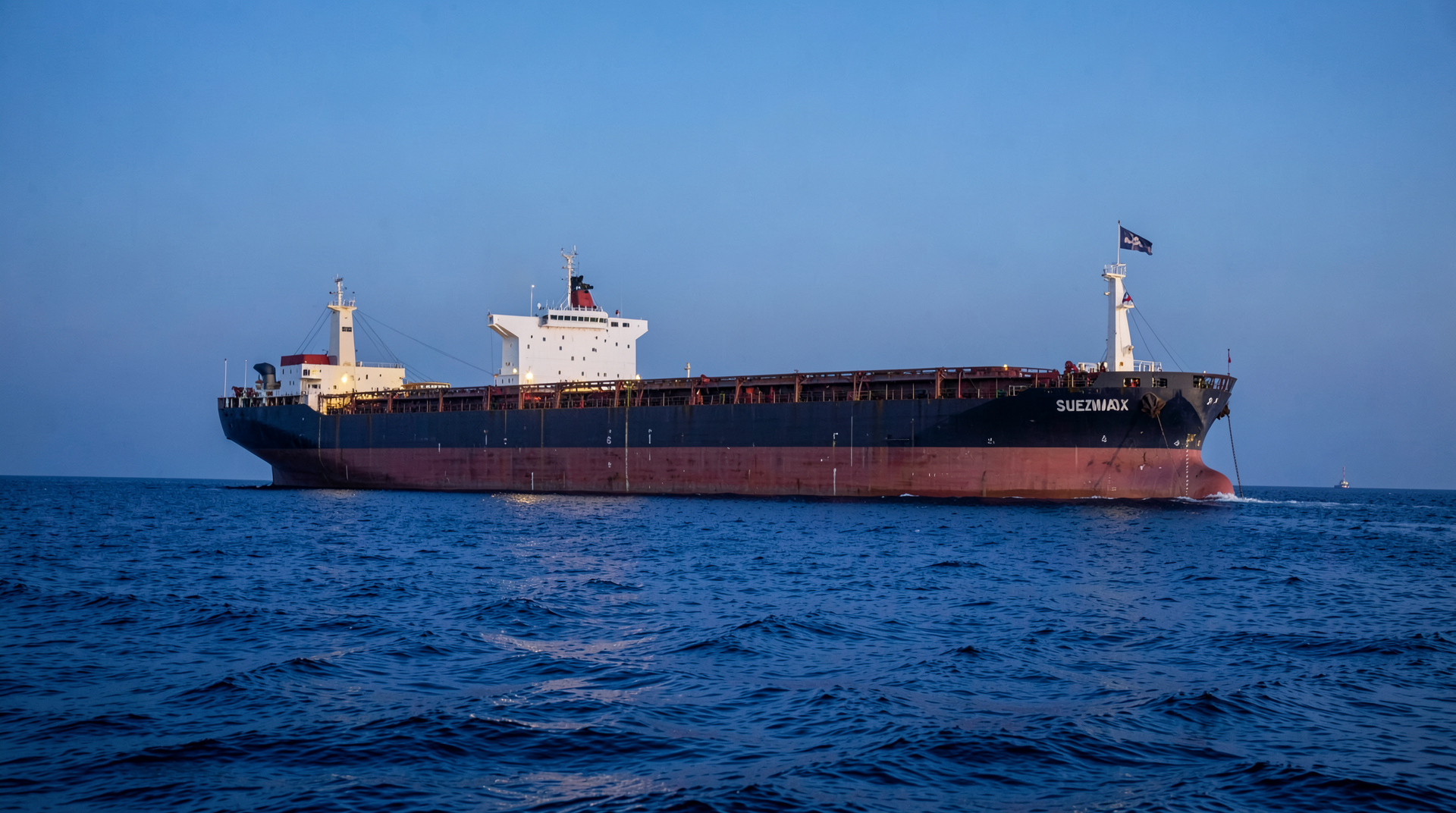 A Suezmax crude tanker riding high in Arabian Gulf anchorage light, Russian-owned by flag-of-convenience registry, US Treasury OFAC license bulletin reproduced as inset.