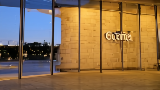 Bollore headquarters lobby glass entrance at dusk, corporate logo on stone wall, empty reception desk