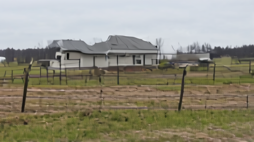 Idaho dairy farm biosecurity gate with quarantine signage and a milking barn in background under overcast sky