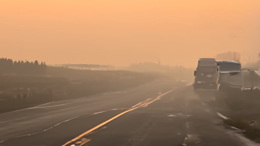 Sheriff's vehicle blocks a coastal Georgia road as smoke from the Brantley fire drifts east