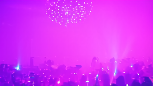 A late-night urban dance floor lit pink and blue with a few dancers in motion under a mirror ball.