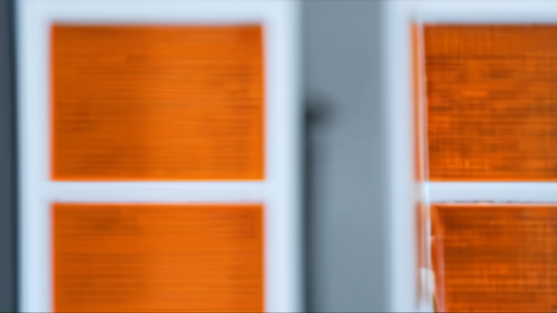 A developer workstation with orange server racks blurred in the background