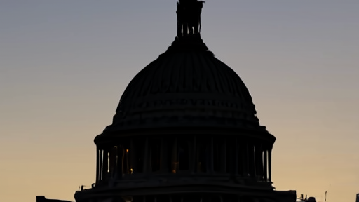 The U.S. Capitol building exterior at dusk with the dome lit and a clear sky.