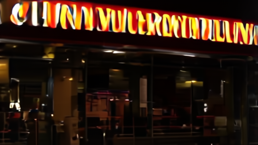 An illuminated movie marquee reading Michael at night.