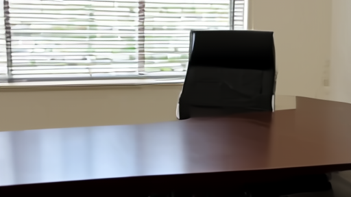 Empty deposition room in a Florida law office with a video camera mounted on a tripod and an empty chair at the head of the table.