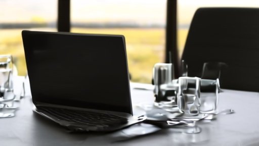 An empty boardroom table with golf-tournament binders and water glasses, set for a strategic-planning meeting.