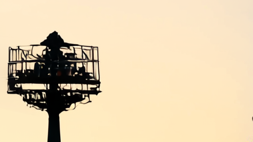 An ABC affiliate broadcast antenna on a clear morning, the network identification on the building partially visible against the sky.