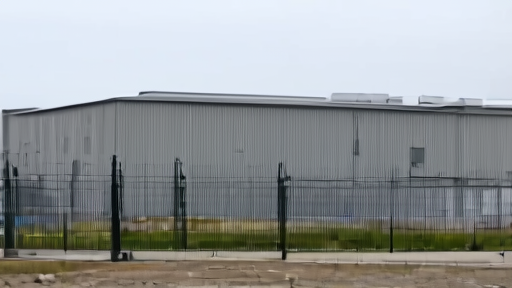 An empty Microsoft data center exterior in Quincy, Washington under a flat overcast sky, security fence, no people, no signage.