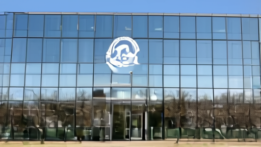 The National Science Foundation headquarters building in Alexandria Virginia at midday with the foundation seal visible at the entrance and an empty visitor plaza.
