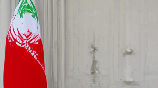 Pezeshkian on the phone in his Tehran office with the presidential standard behind him.