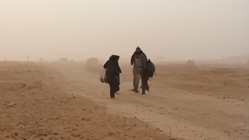 A Sudanese family on the road outside Khartoum carrying belongings in early-morning light.