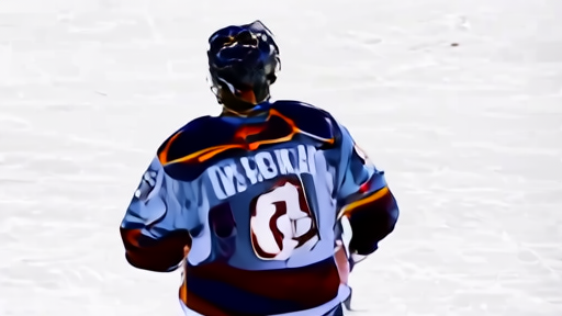 MacKinnon mid-celebration on the Ball Arena ice after Game 2 with the scoreboard visible in the background showing the 2-0 series lead
