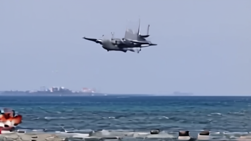 F/A-18E Super Hornet banking over the Gulf of Oman at altitude with a disabled tanker visible below trailing smoke