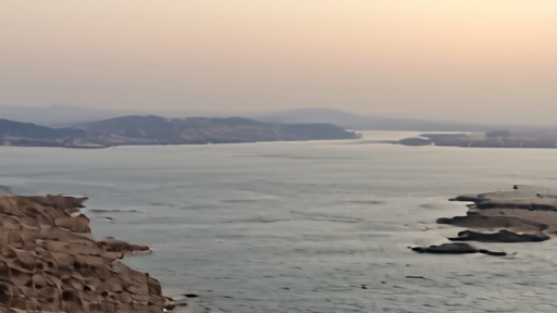 LNG tanker transiting the Strait of Hormuz at dawn