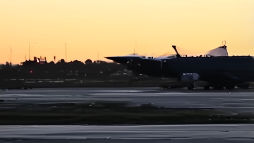 Military aircraft silhouettes on a tarmac at dusk with Pakistani flag visible