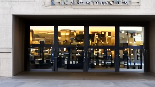 Marriner S. Eccles Federal Reserve building entrance under flat morning light with the bronze seal centered above the doors.