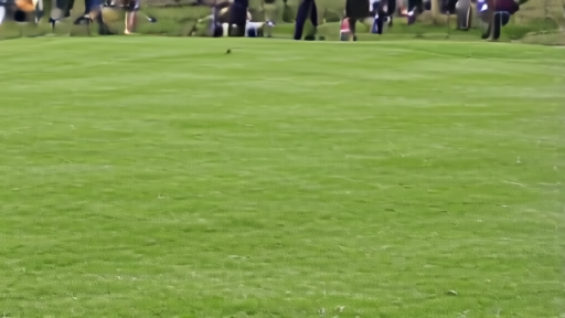 A golfer walking up an eighteenth fairway with a broadcast camera nearby