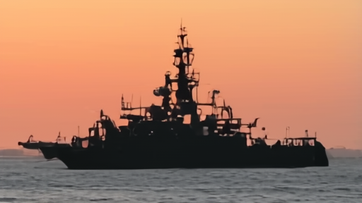 US Navy mine-countermeasures ship operating in the Persian Gulf at dusk