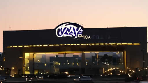 The Adani Group headquarters in Ahmedabad photographed at dusk, the company logo lit against a darkening sky.