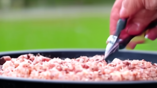 A hand presses an instant-read thermometer into a chicken breast on a backyard charcoal grill, the digital readout visible