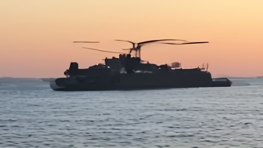 United States military helicopter flying over commercial tanker near the Strait of Hormuz.