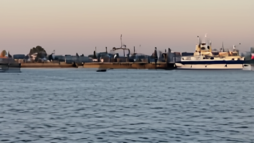 Detention area at Israeli port with Israeli police and flotilla vessels in background.