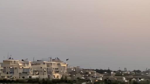 View of Muscat's Royal Opera House at dusk with the Omani Foreign Ministry building visible in background.