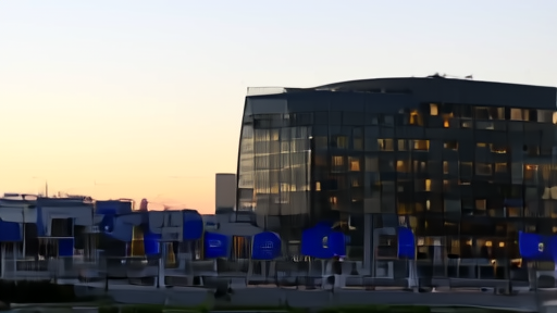 European Commission Berlaymont facade at dusk with EU flags.