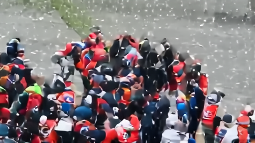 Daniel Suárez on the Charlotte victory stand in confetti, helmet in hand, Spire crew embracing him
