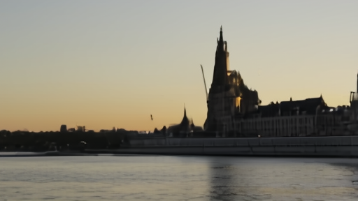 The Hungarian Parliament Building in Budapest at dawn with the Danube River reflecting the facade.