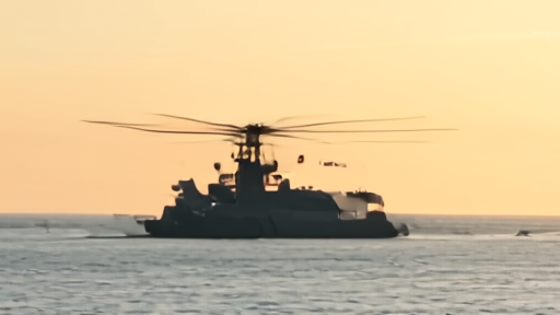 Ship 39 silhouette against the Indian Ocean horizon just after splashdown, helicopter rotor in foreground
