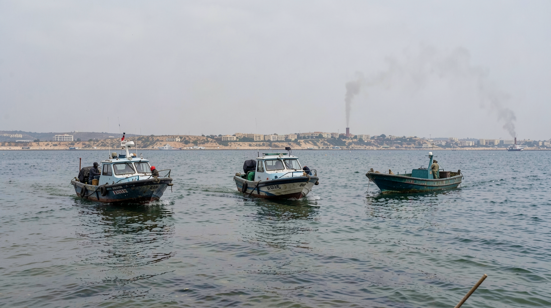 Iranian patrol boats in shallow Gulf waters near the port of Bandar Abbas under an overcast sky