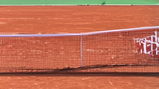 Clay court with a scoreboard and tennis bags after a first-round match