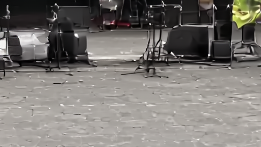 Outdoor concert stage with empty microphone stands under patriotic bunting