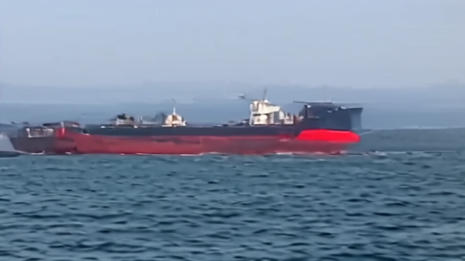 A tanker in the Strait of Hormuz beside shipping risk forms