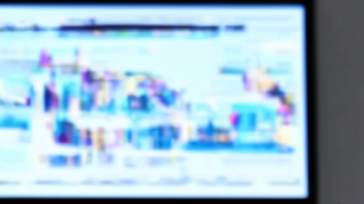 Empty ad sales conference room with a blurred streaming dashboard