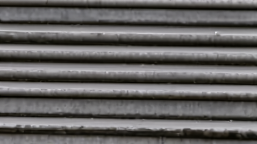 Supreme Court steps reflected in a shipping-container lock and customs paperwork