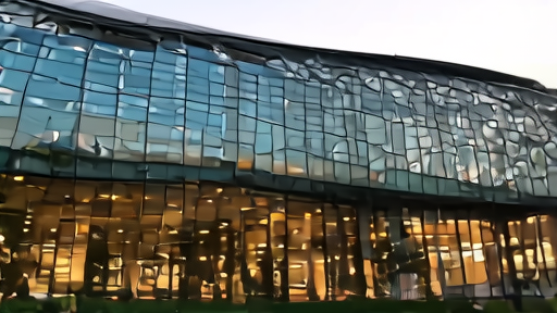 Apple Park campus exterior with glass walls reflecting sunset light