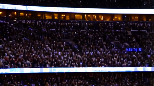 Madison Square Garden's exterior at night with a sold-out crowd visible through the glass