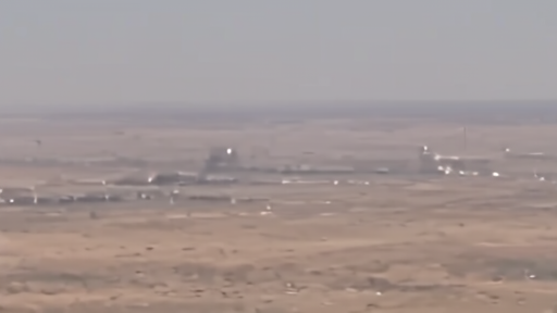 CENTCOM footage frame showing aerial view of strike targets with explosion plumes rising