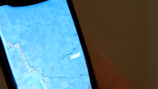 Dark map of Iran with no connectivity indicators, a single lit phone screen in the foreground