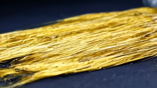 Golden shimmering fiber threads from a pen shell mussel on a laboratory surface